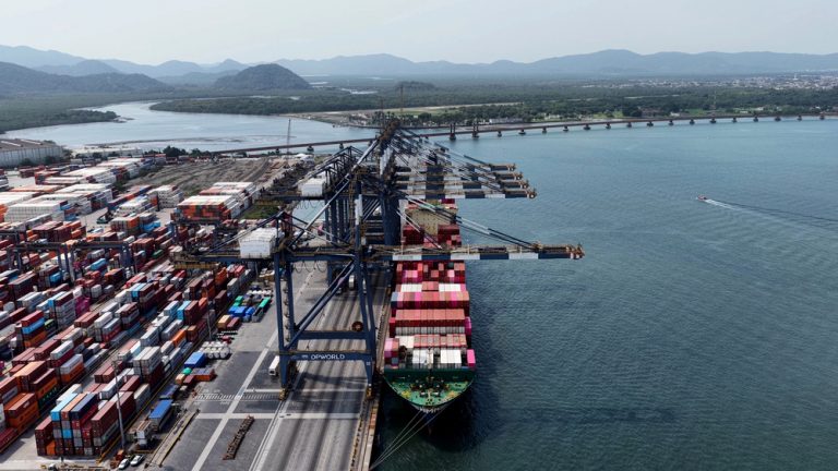 Vista de cima de parte do Porto de Santos (SP) mostra pilhas de contêineres e navio sendo carregado
